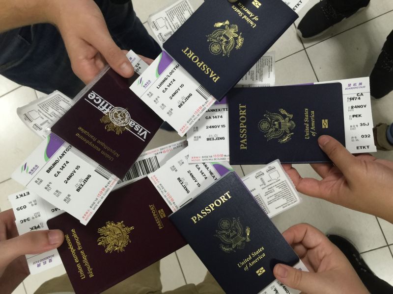 people holding passports in a circle